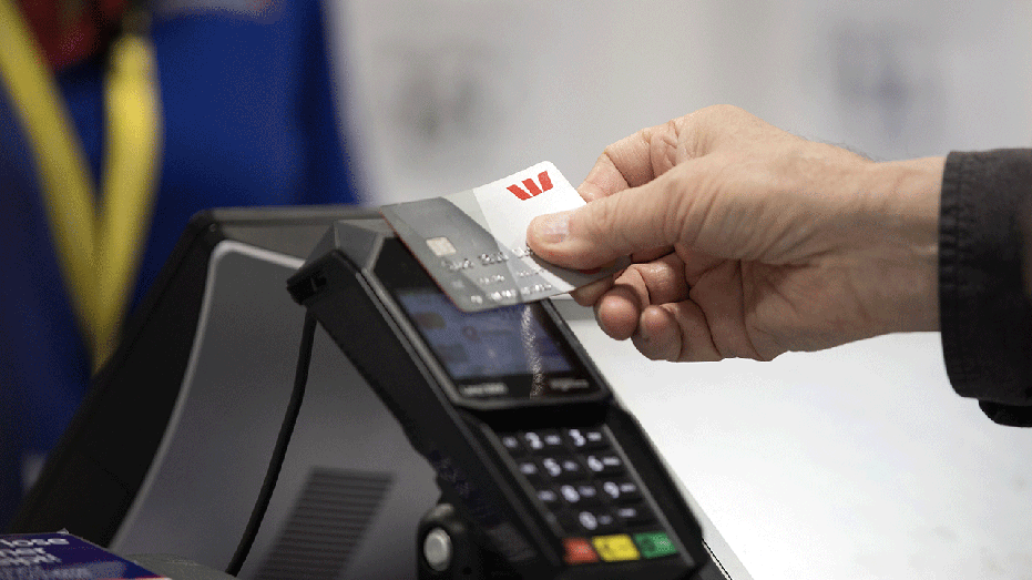 Person tapping credit card on reader