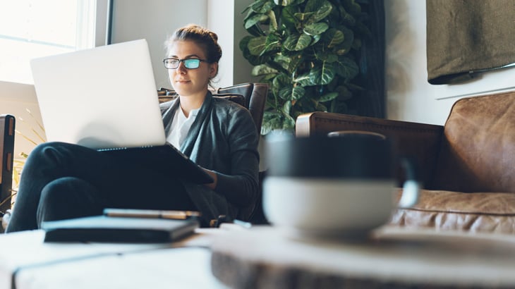 Woman working on her laptop from home