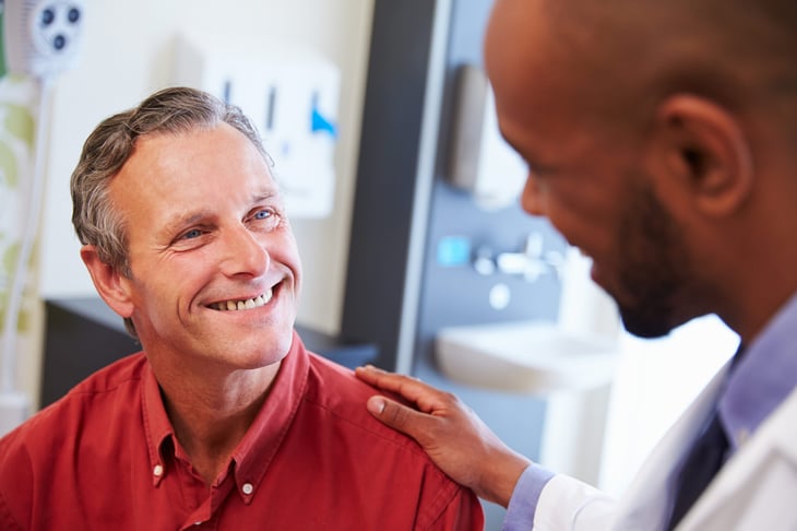 Patient smiling at his doctor